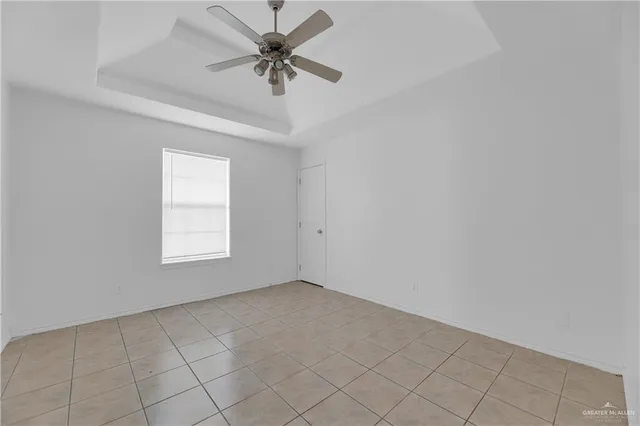 an empty room with a empty space and a ceiling fan