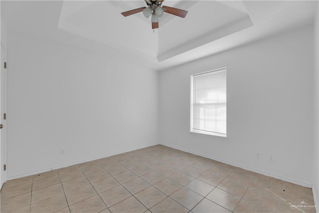 2213 North Dahlia Street, Unit 2 Pharr, TX 78577 - Photo 14 of 18 an empty room with a window and a ceiling fan