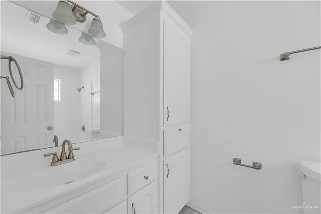 a bathroom with a sink and vanity