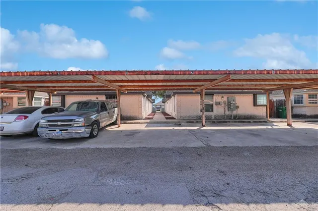 a view of a car park in front of a house