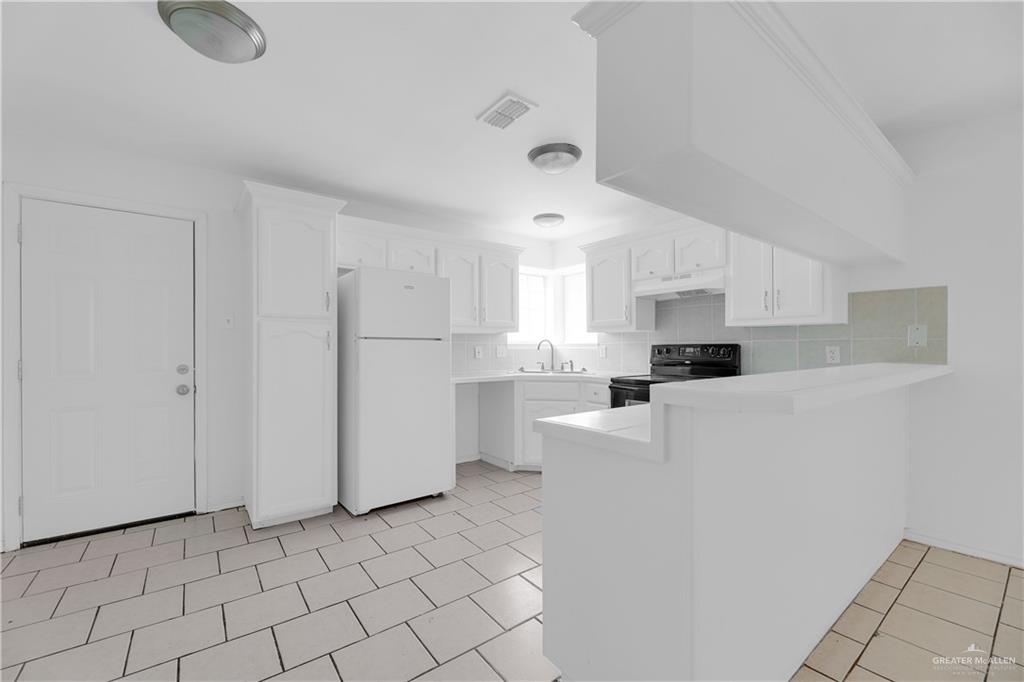 2213 North Dahlia Street, Unit 2 Pharr, TX 78577 - Photo 10 of 18 a kitchen with stainless steel appliances a refrigerator sink and white cabinets
