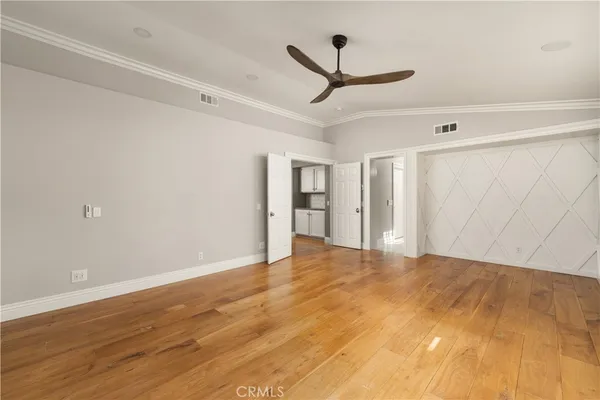 a view of empty room with wooden floor