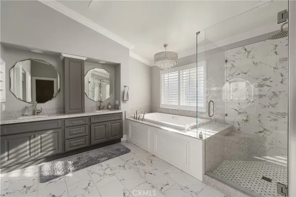 a spacious bathroom with double vanity and a bathtub