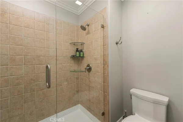 a bathroom with a shower a toilet and sink