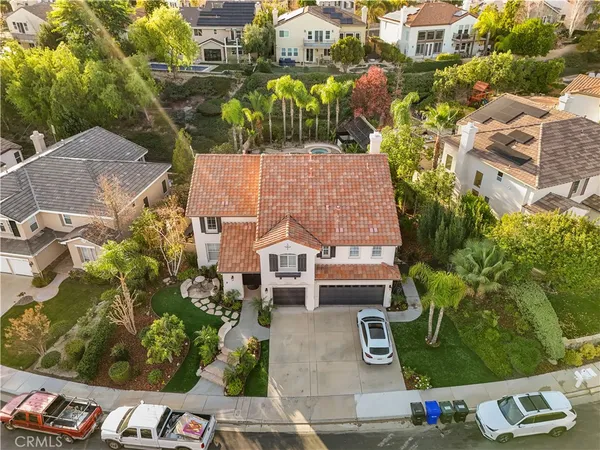 an aerial view of a house with garden space and street view