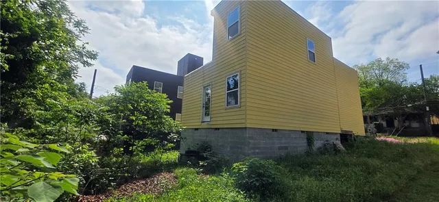 a backyard of a house with plants and tree