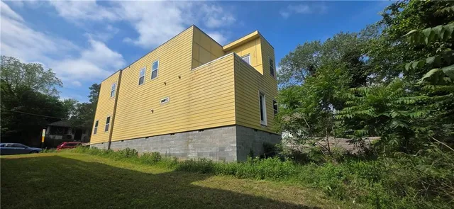 a view of house with backyard and garden