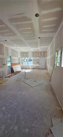 a living room with lots of furniture and a chandelier