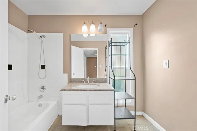 a bathroom with a tub sink and mirror