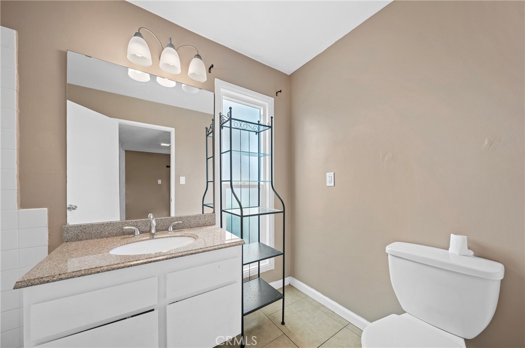 1192 Mitchell Avenue, Unit 70 Tustin, CA 92780 - Photo 14 of 29 a bathroom with a toilet a sink and mirror
