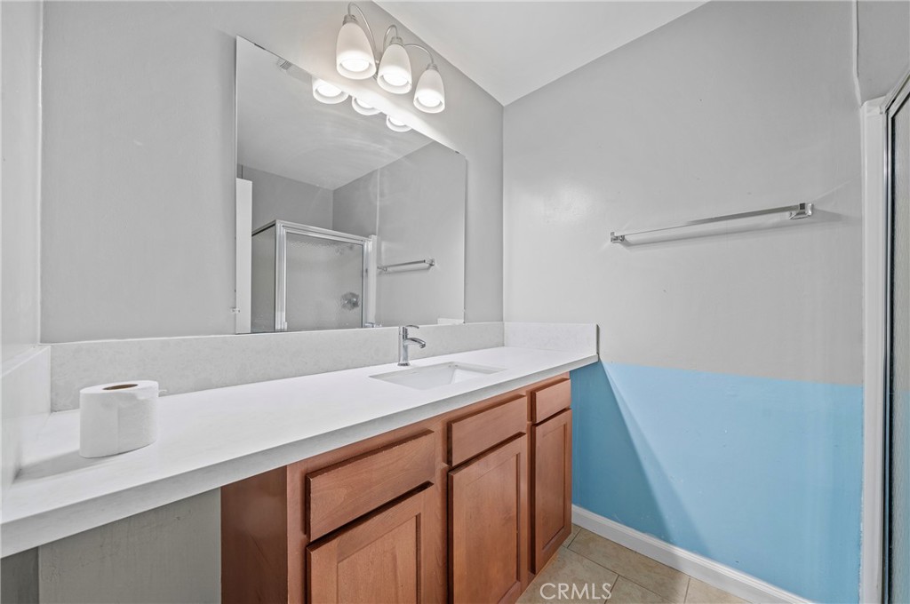 1192 Mitchell Avenue, Unit 70 Tustin, CA 92780 - Photo 19 of 29 a bathroom with a sink a vanity and a mirror