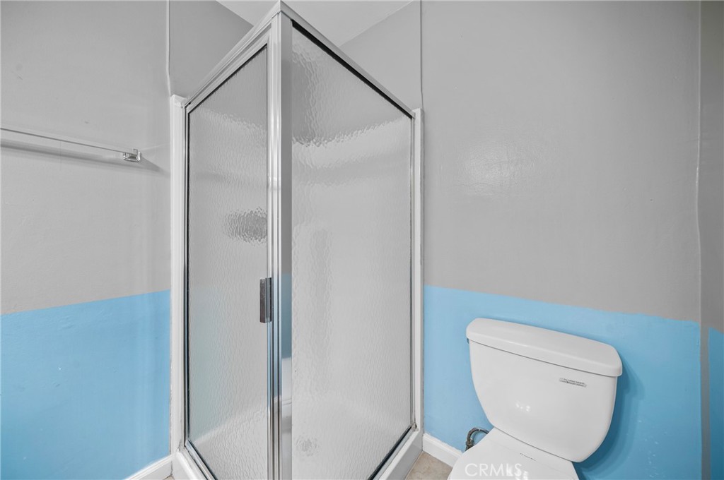 1192 Mitchell Avenue, Unit 70 Tustin, CA 92780 - Photo 20 of 29 a bathroom with a toilet and a shower