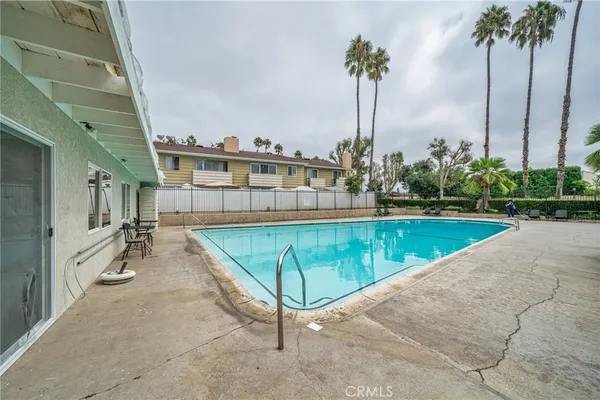 a view of a swimming pool with a garden and a chair