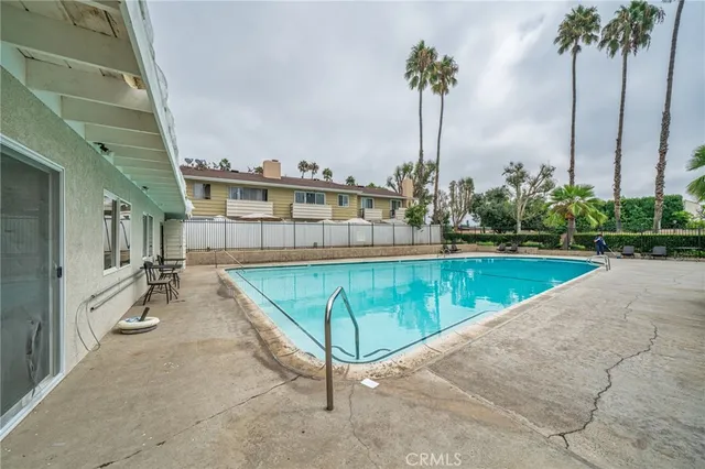 a view of a swimming pool with a garden and a chair