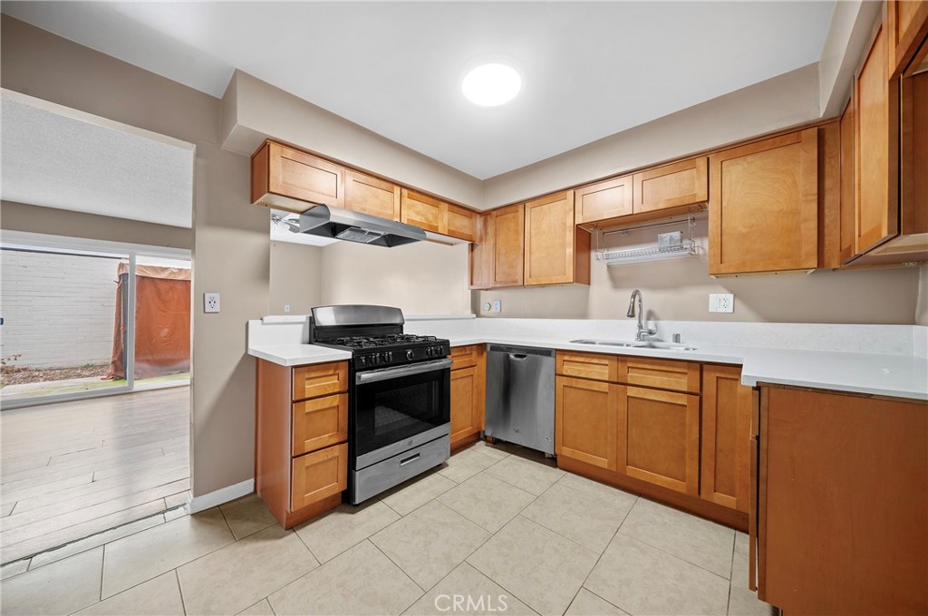 1192 Mitchell Avenue, Unit 70 Tustin, CA 92780 - Photo 5 of 29 a kitchen with stainless steel appliances granite countertop a sink and a stove