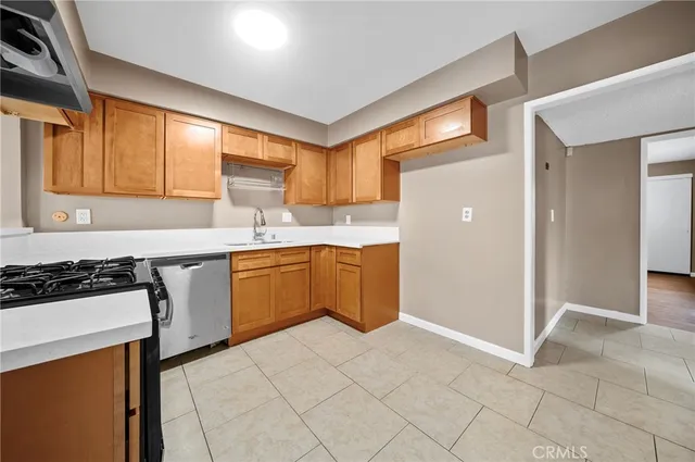 a kitchen with a stove a sink and a refrigerator