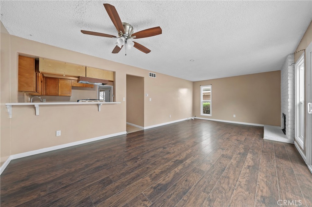 1192 Mitchell Avenue, Unit 70 Tustin, CA 92780 - Photo 7 of 29 a view of a livingroom with wooden floor and a ceiling fan