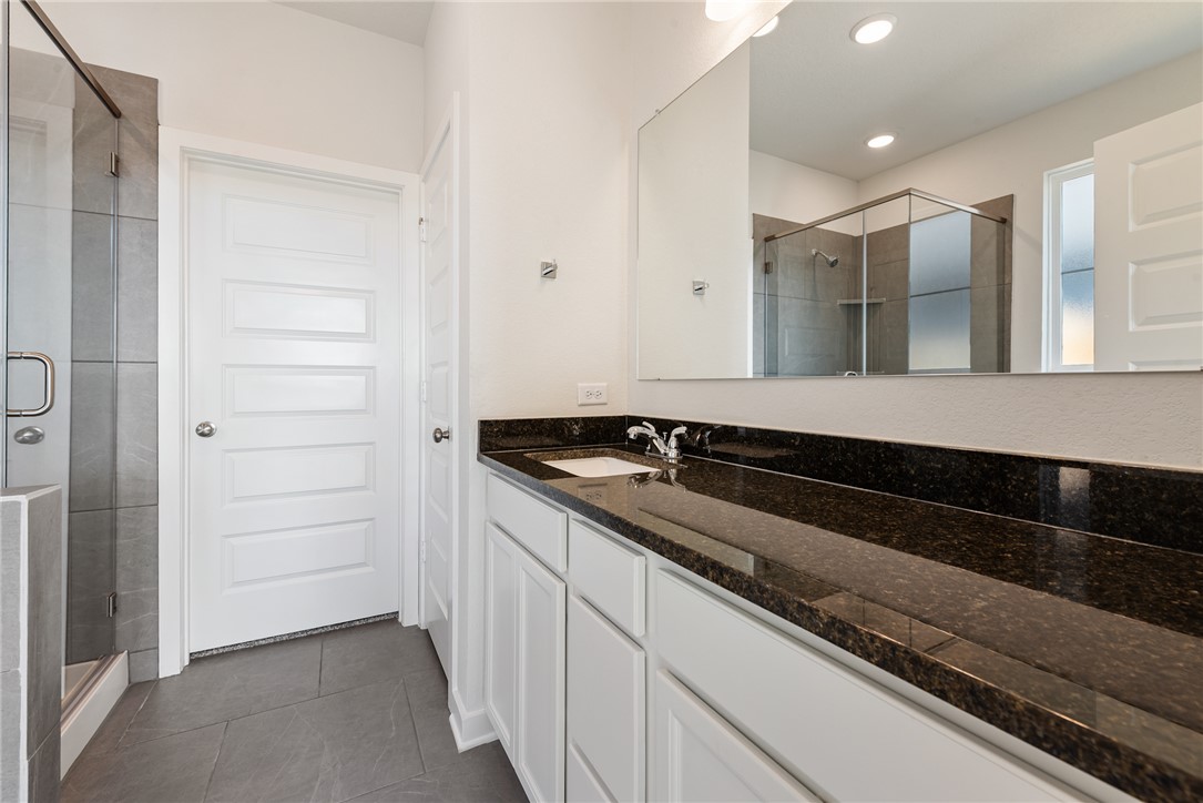 2415 Rooke Road Bryan, TX 77807 - Photo 32 of 36 a bathroom with a sink and a mirror