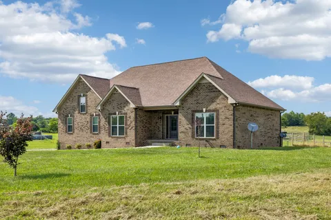 a front view of house with yard and green space