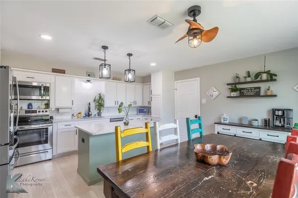 a kitchen with stainless steel appliances granite countertop a sink and stove