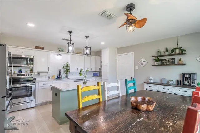 a kitchen with stainless steel appliances granite countertop a sink and stove