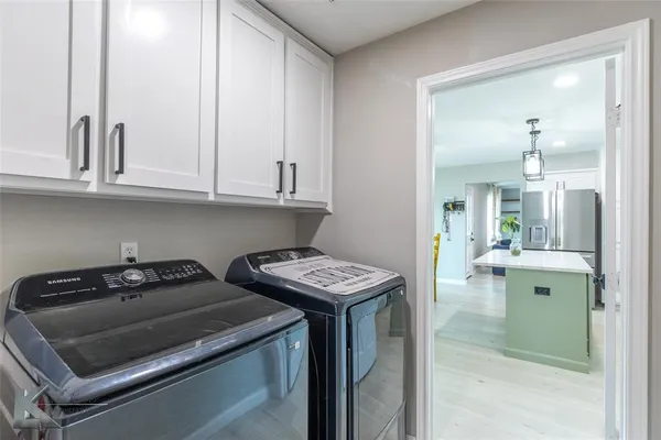a kitchen with stainless steel appliances granite countertop a sink and cabinets
