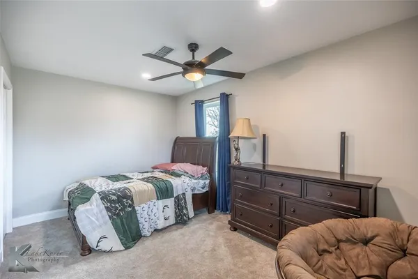 a bedroom with bed and window