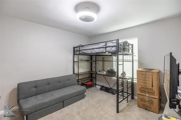 a living room with furniture a ceiling fan and a window