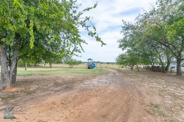 an aerial view of a house with a yard and lake view