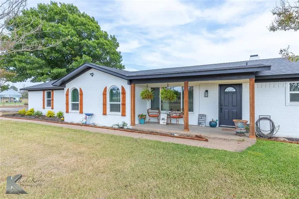 a front view of house with yard and seating area