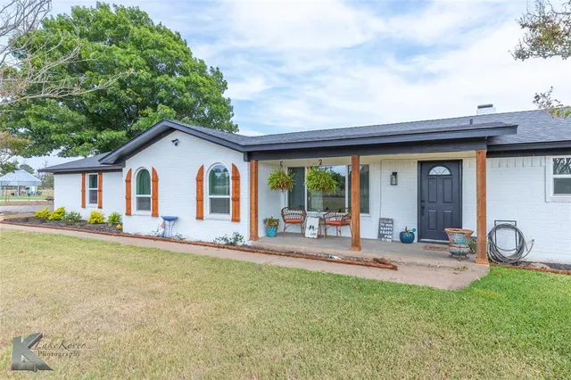 a front view of house with yard and seating area