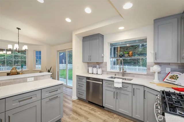 a kitchen with stainless steel appliances a refrigerator sink and cabinets