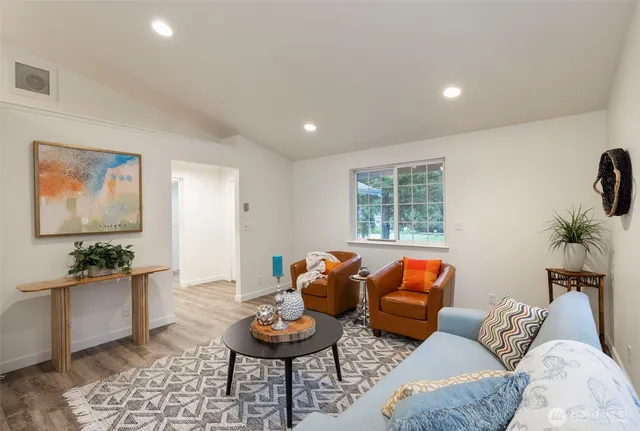 a living room with furniture and a large window