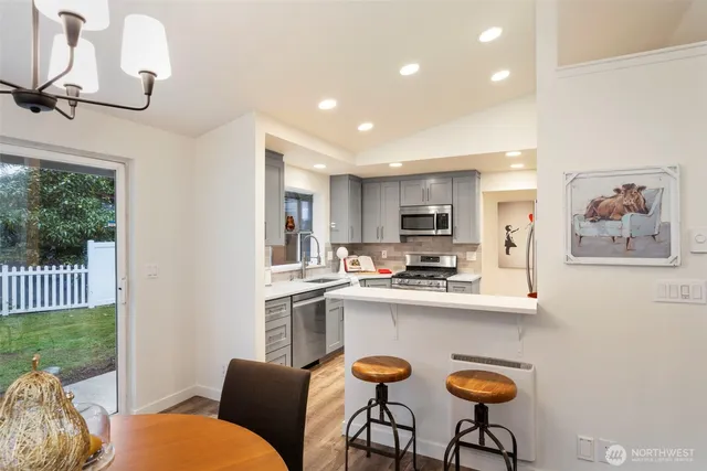 a kitchen with stainless steel appliances a refrigerator sink and microwave