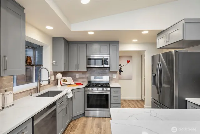 a kitchen with a sink stove and cabinets