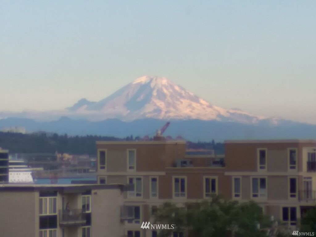 519 West Roy Street, Unit 408 Seattle, WA 98119 - Photo 24 of 25 a view of a building with mountains in the background