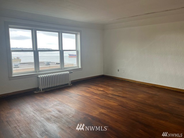 519 West Roy Street, Unit 408 Seattle, WA 98119 - Photo 7 of 25 an empty room with wooden floor and windows