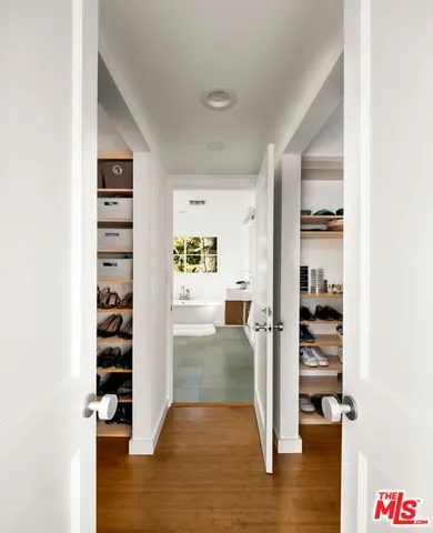 a view of a hallway view with wooden floor and windows