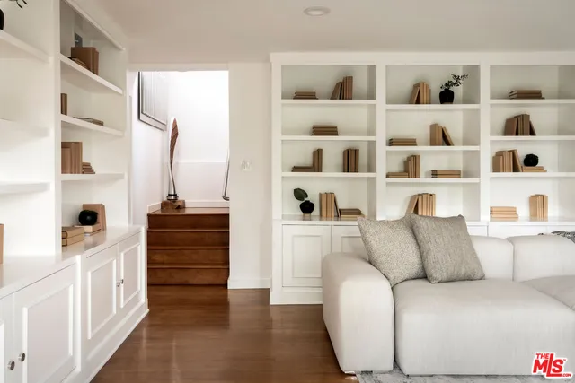 a living room with furniture and a book shelf