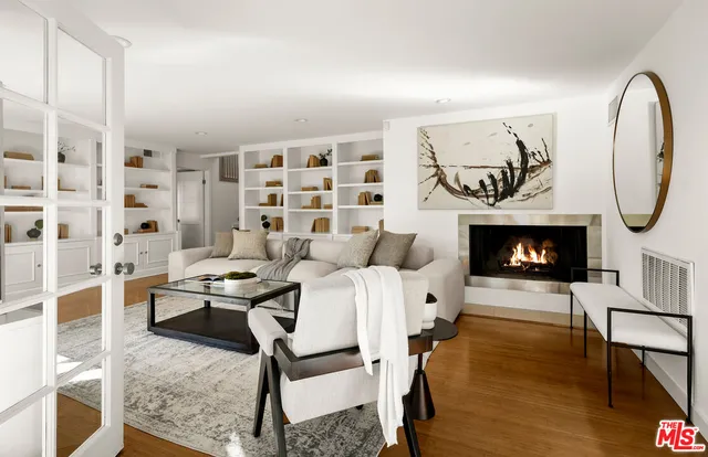 a living room with furniture a table and a fireplace