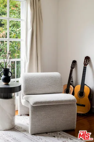 a living room with furniture and a floor to ceiling window