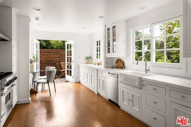 a kitchen with sink and cabinets