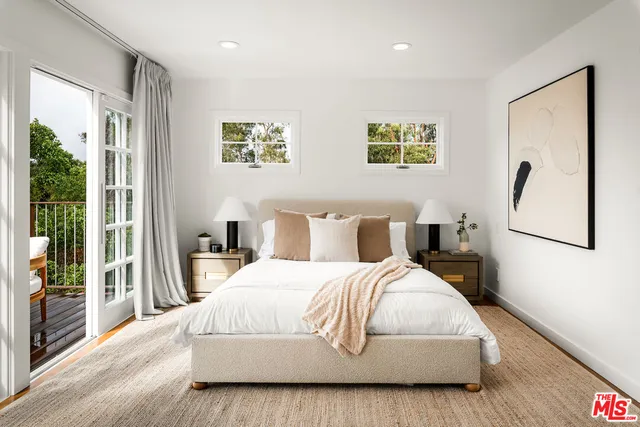 a bedroom with a large bed and a large window