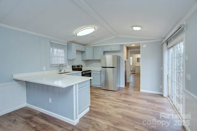 a kitchen with stainless steel appliances a sink stove and refrigerator