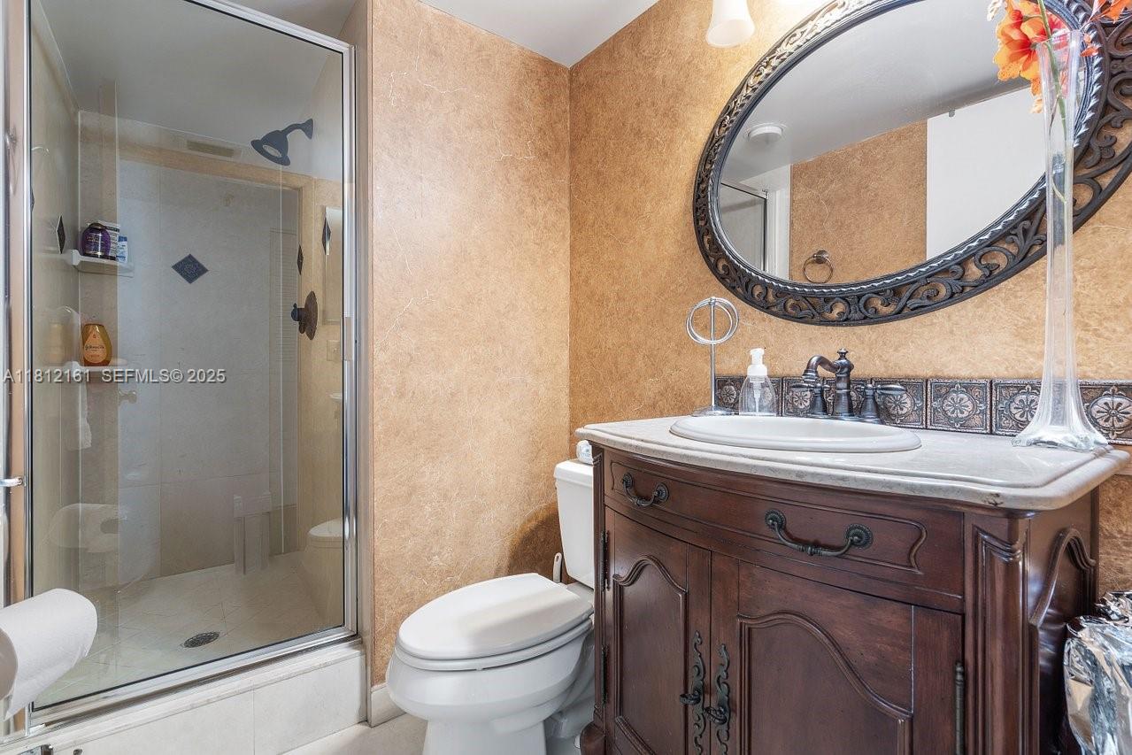 9235 Southwest 8th Street, Unit 502 Boca Raton, FL 33428 - Photo 7 of 21 a bathroom with a sink and a mirror