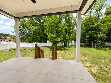 a view of a house with backyard porch and sitting area