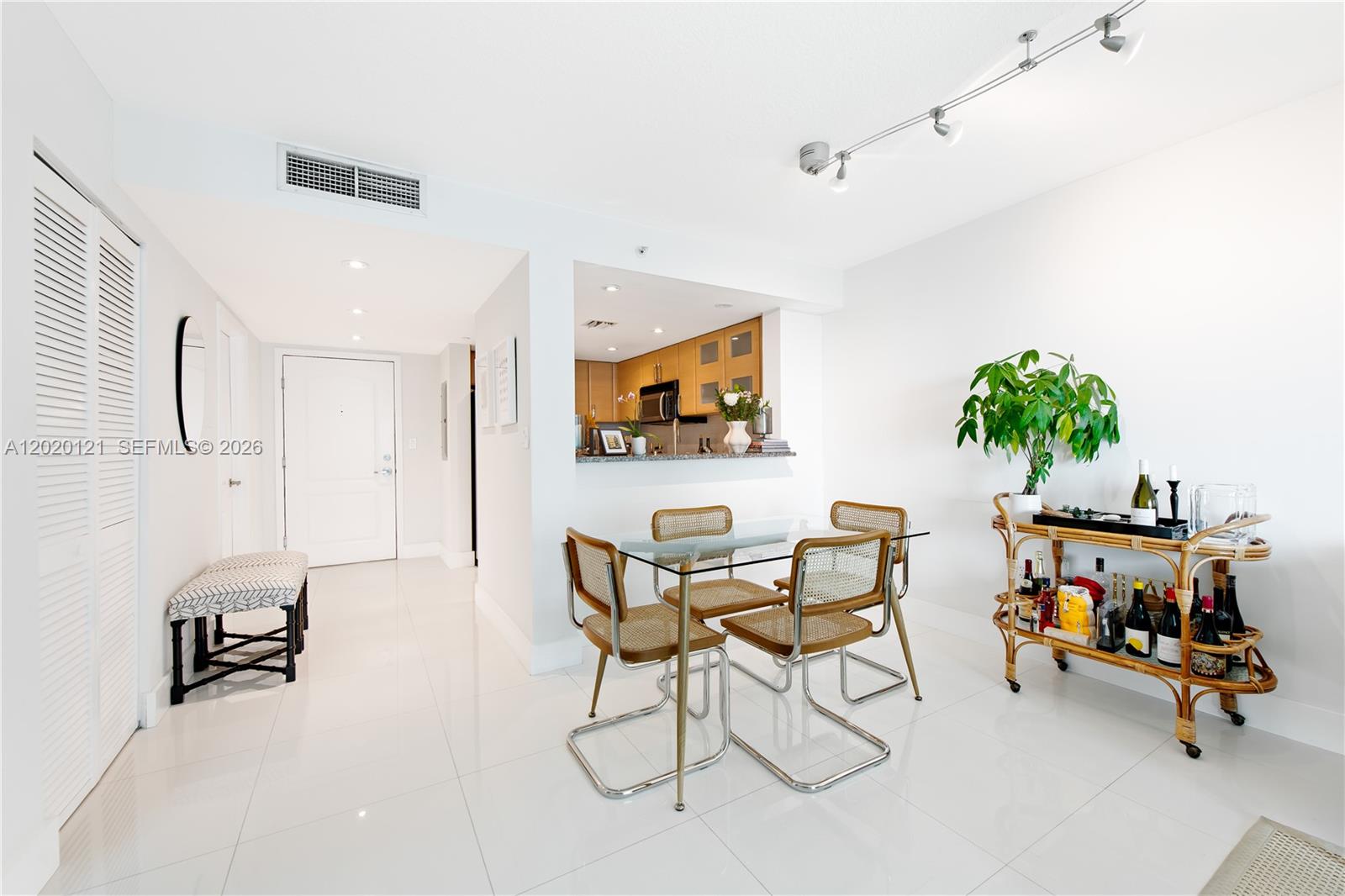 2101 Brickell Avenue, Unit 1909 Miami, FL 33129 - Photo 6 of 25 a living room with furniture and a flat screen tv