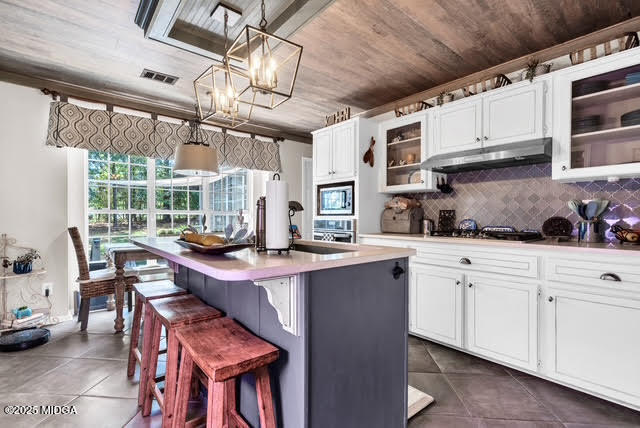 116 Newport Road Northeast Milledgeville, GA 31061 - Photo 11 of 30 a kitchen with stainless steel appliances granite countertop a sink and cabinets
