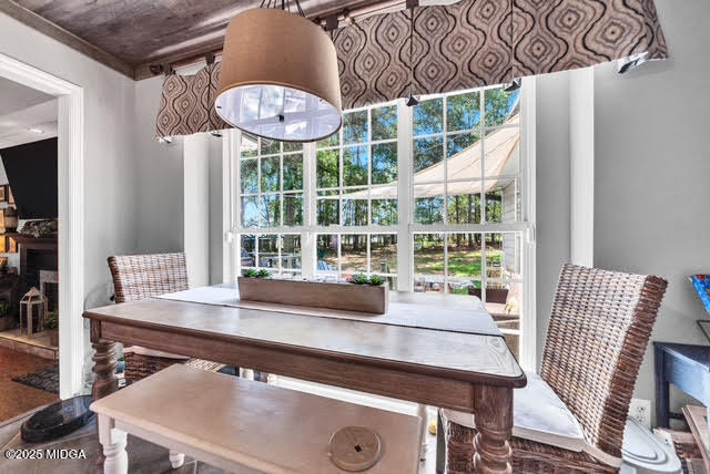 116 Newport Road Northeast Milledgeville, GA 31061 - Photo 12 of 30 a view of a dining room with furniture a chandelier and wooden floor