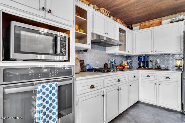 116 Newport Road Northeast Milledgeville, GA 31061 - Photo 14 of 30 a kitchen with white cabinets and appliances